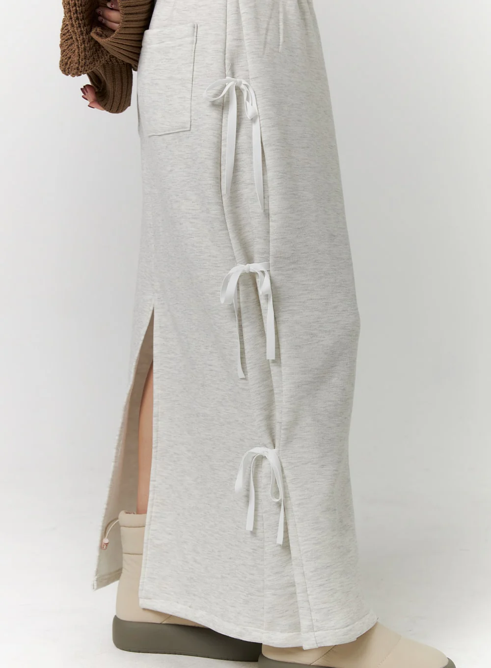 A Long Skirt With Slits On Both Sides, A Tie-up Design, And A Back Slit; Available In A Variety Of Colors